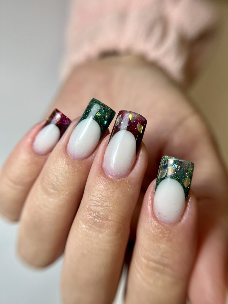 woman's hand with red and green french manicure, nail design, christmas